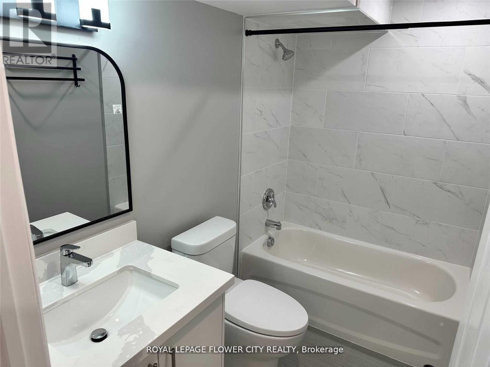 A white sink and toilet in a bathroom.