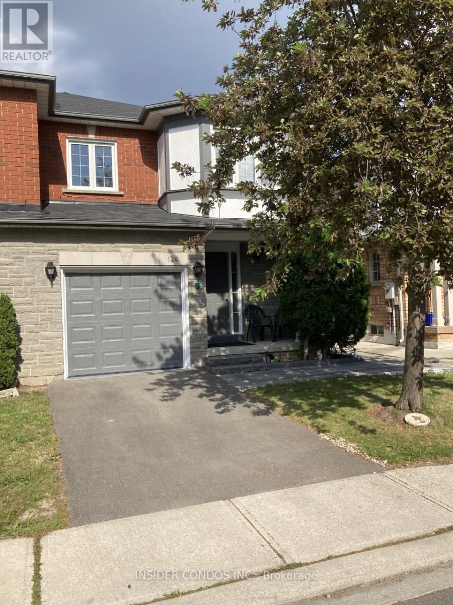A house with a grey garage door is for sale.