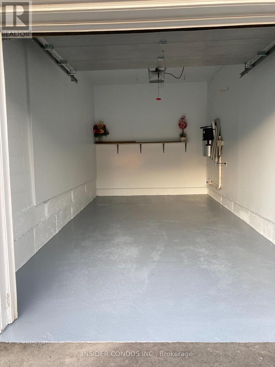 A spacious garage with white walls and a concrete floor.