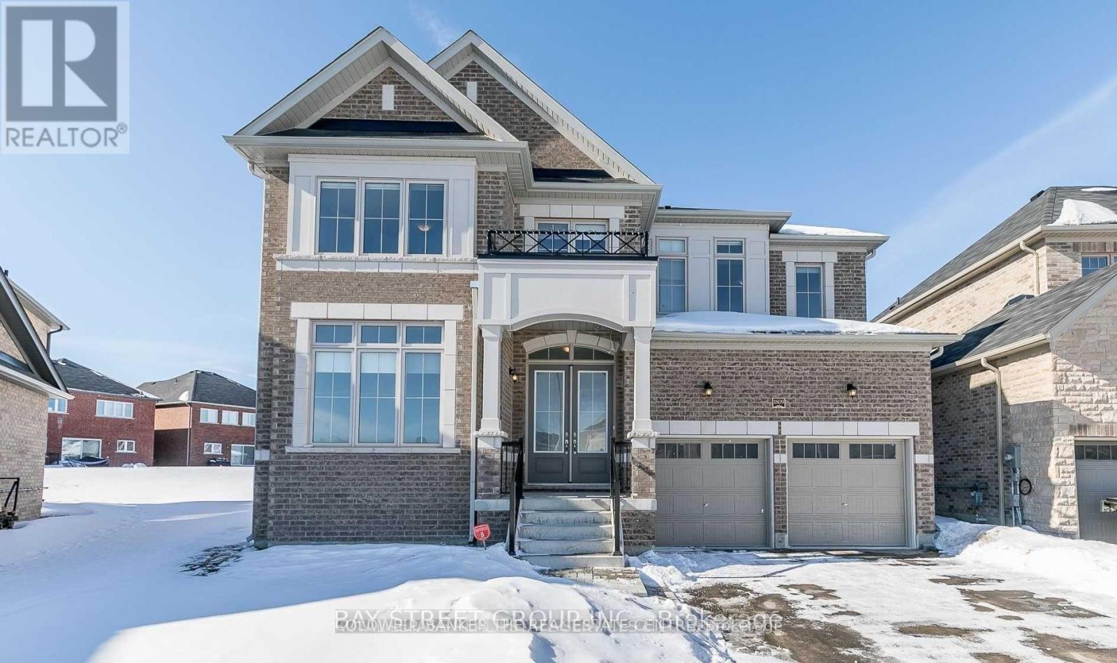 A large house with a snow-covered front yard.