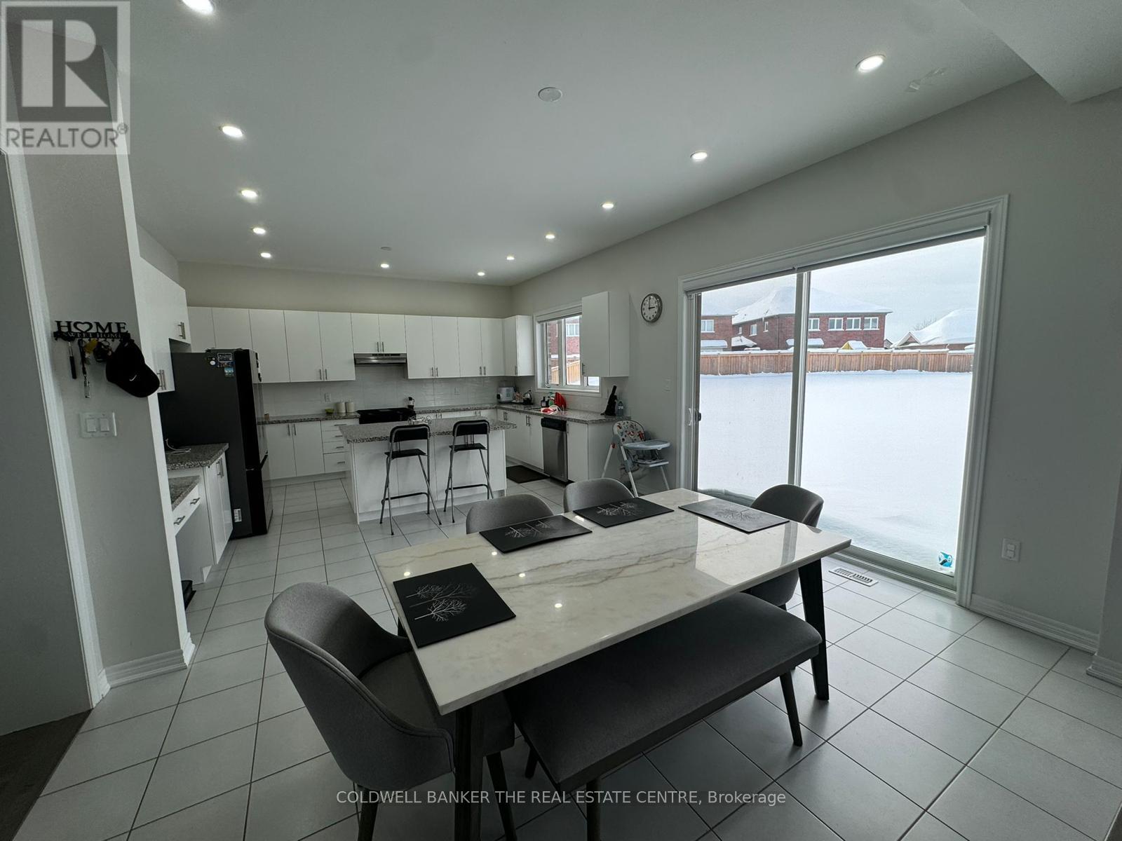 A modern kitchen with a dining table and chairs.