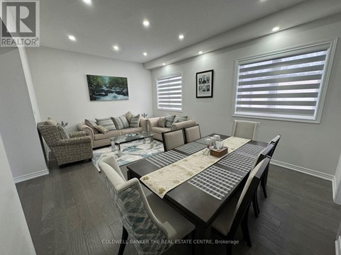 A well-lit, spacious living room with a dining table and chairs.
