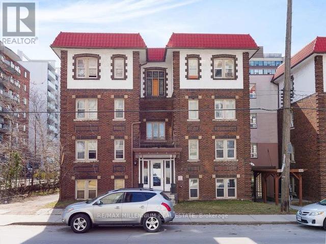 A building with a red roof and a sign that says RE/MAX Millennium Realty.