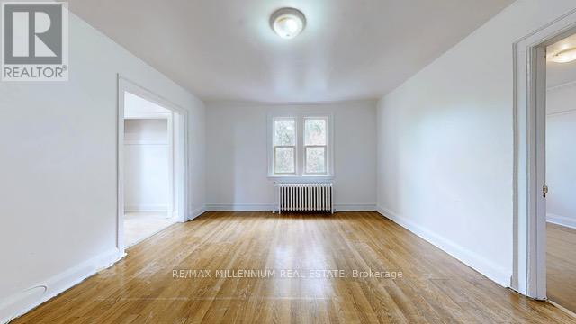 A room with a window and a radiator on the wall.