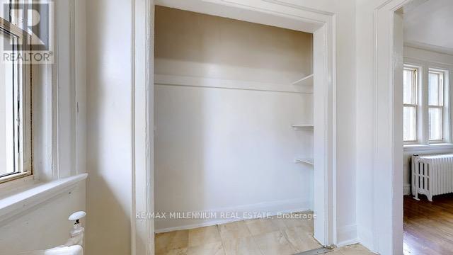 A room with white walls and a window.