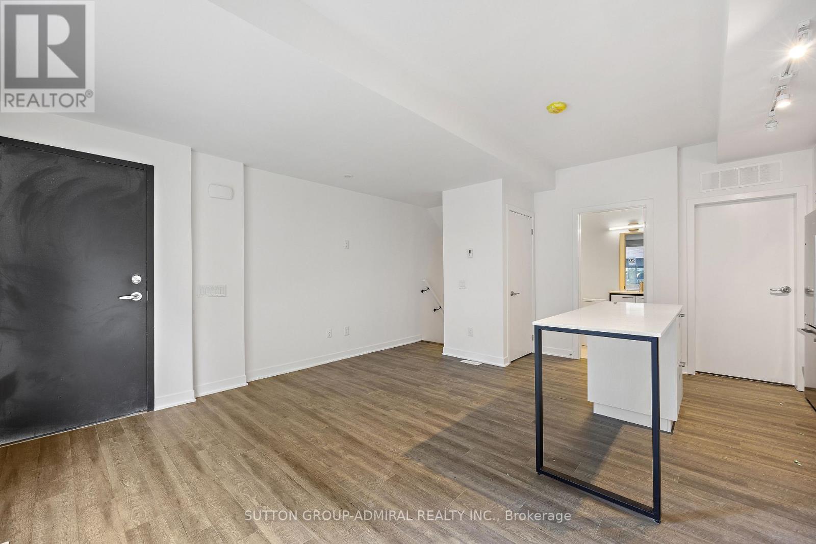 A room with a black door and a white cabinet.