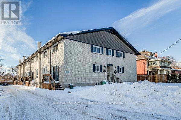 A house with a snow-covered ground in front of it.
