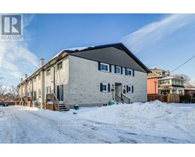 A house with a snow-covered ground in front of it.