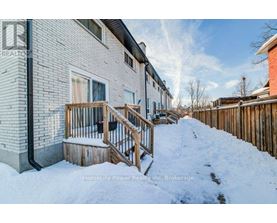 A snow-covered front yard of a residential building.