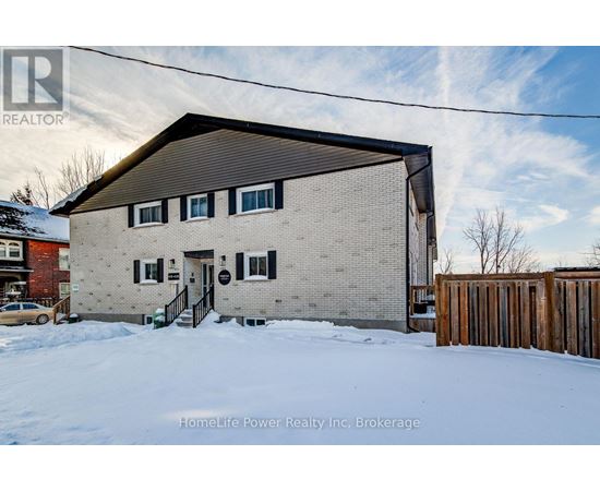 A house with a snowy front yard.