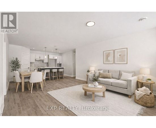 A well-lit, spacious living room with a dining area and a kitchen in the background.