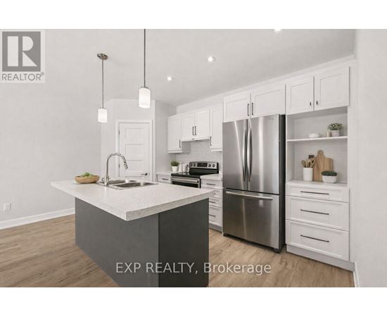 A kitchen with white cabinets and a large island.
