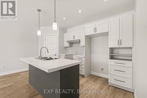 A kitchen with white cabinets and a large island.
