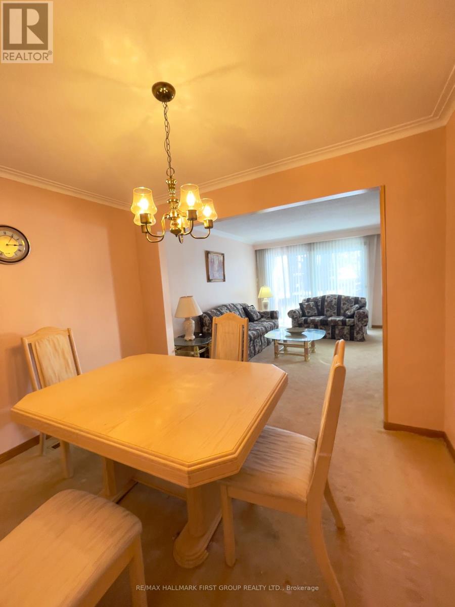 A dining room with a table and chairs.
