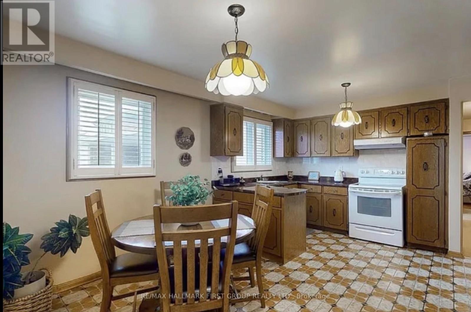 A kitchen with a table and chairs in the middle of the room.