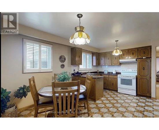A kitchen with a table and chairs in the middle of the room.