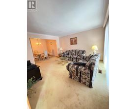 A living room with a couch, chair, and lamp.