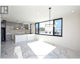A spacious, modern room with a marble floor and a view of the outside through large windows.
