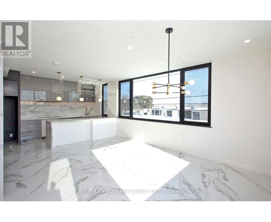 A spacious, modern room with a marble floor and a view of the outside through large windows.