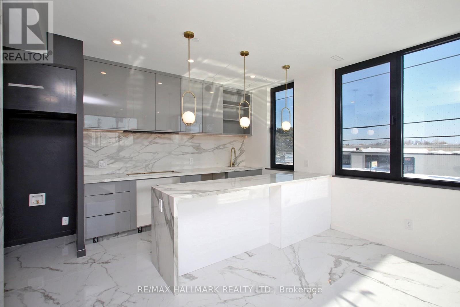 A modern kitchen with a marble countertop and a large island.