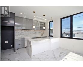 A modern kitchen with a marble countertop and a large island.
