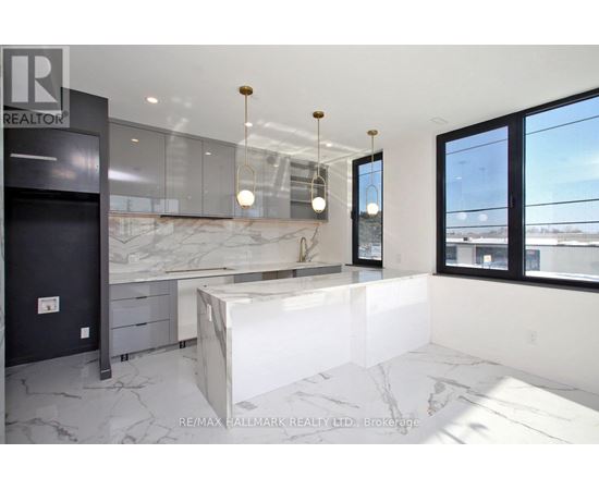 A modern kitchen with a marble countertop and a large island.