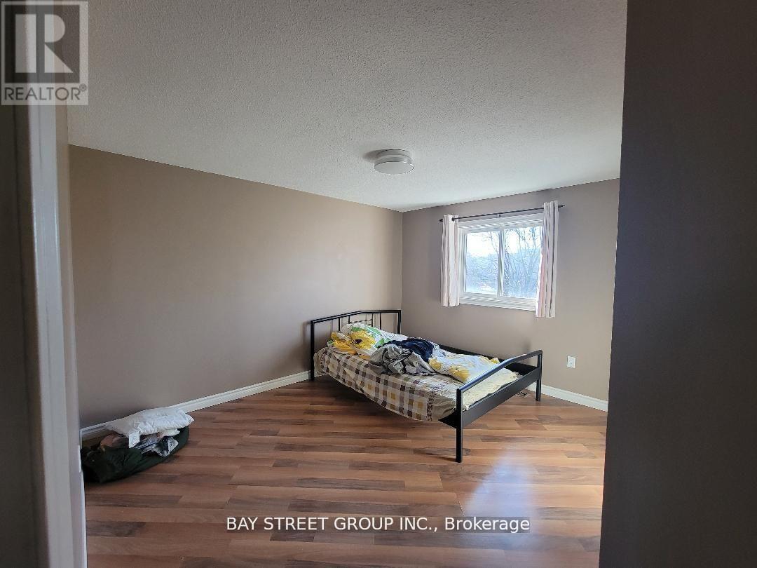 A bedroom with a bed and a window.