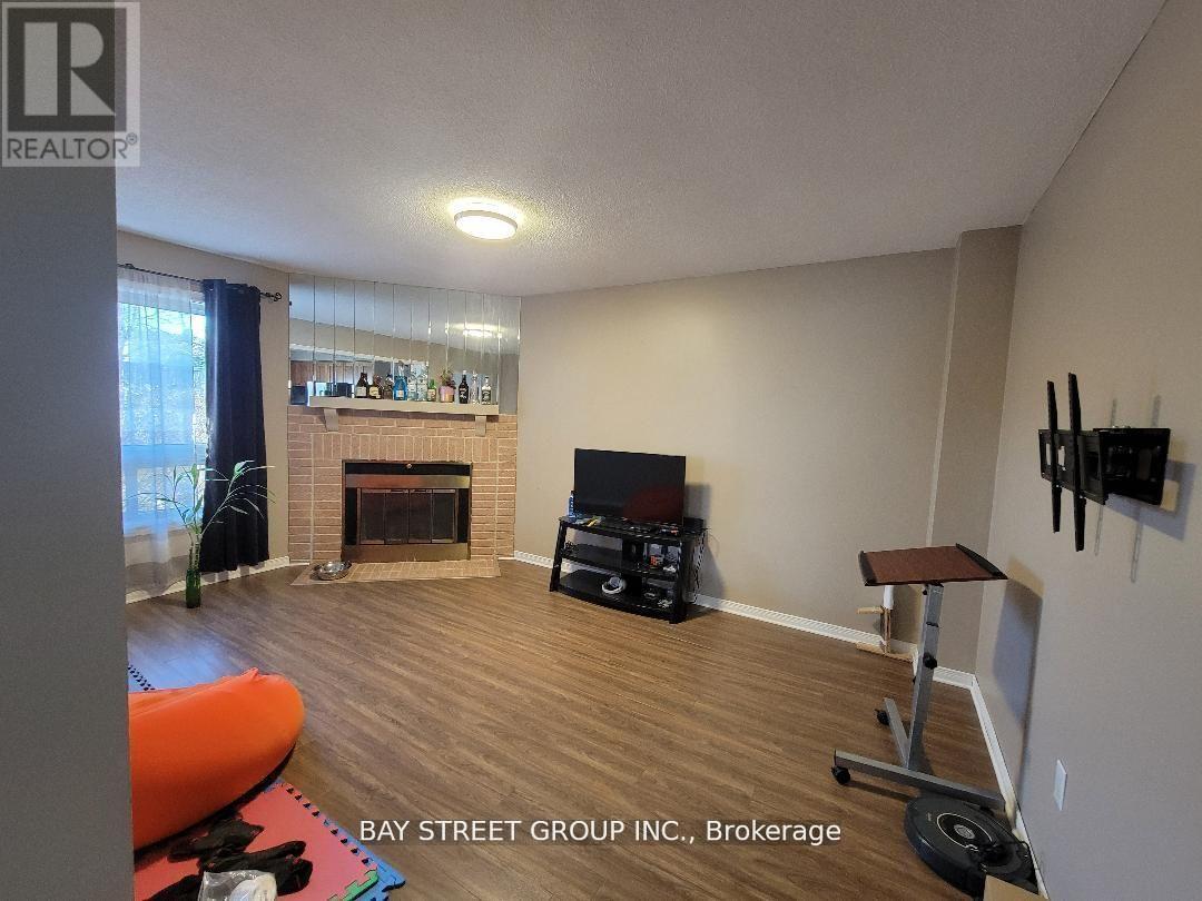 A living room with a fireplace and a television.