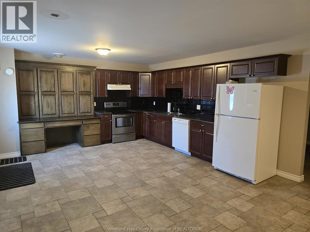 A kitchen with a white fridge and wooden cabinets.