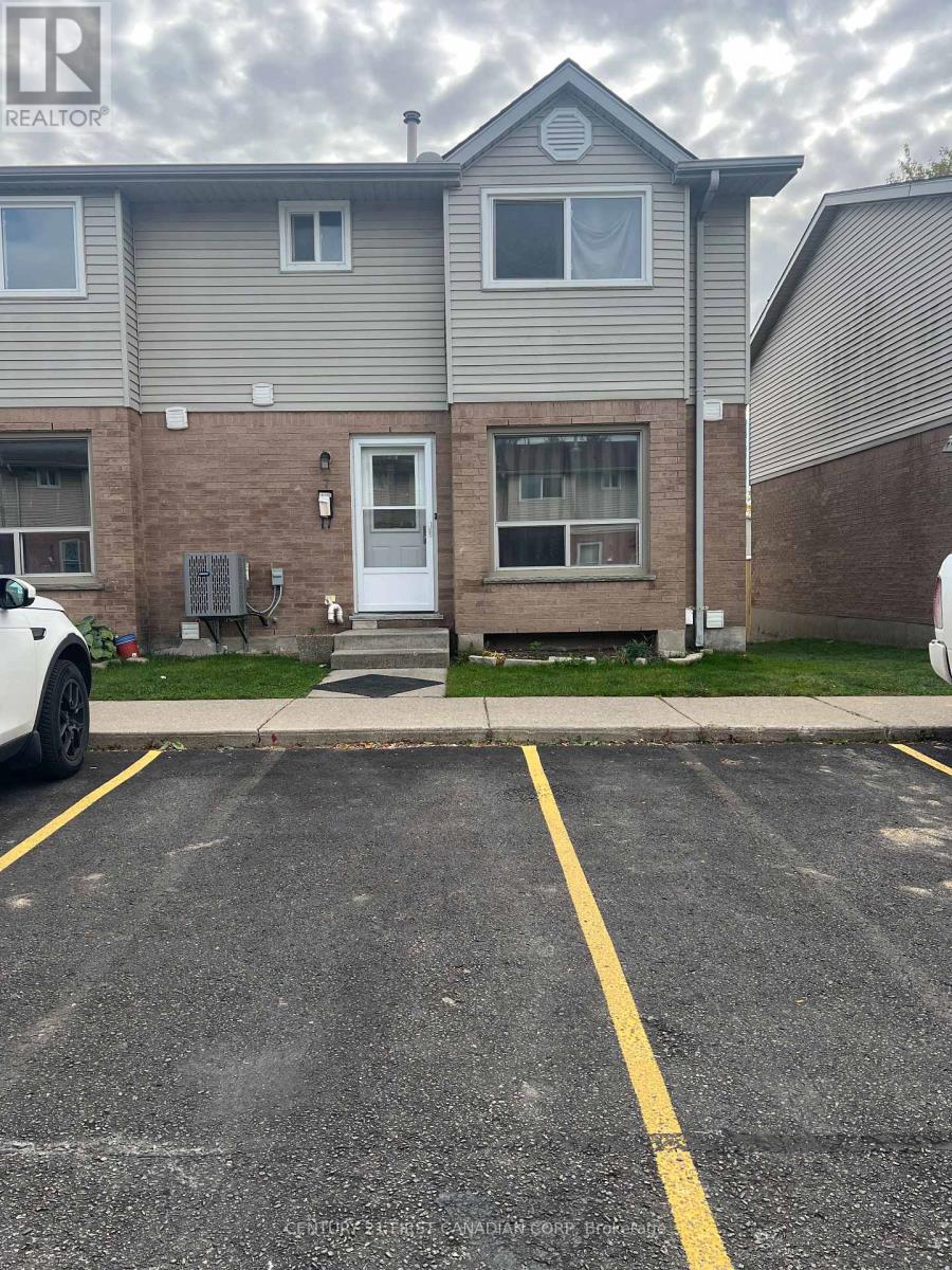 A grey house with a white car parked in front.