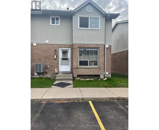 A grey house with a white door and windows.