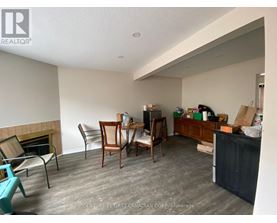 A room with a fireplace and a dining table with chairs.