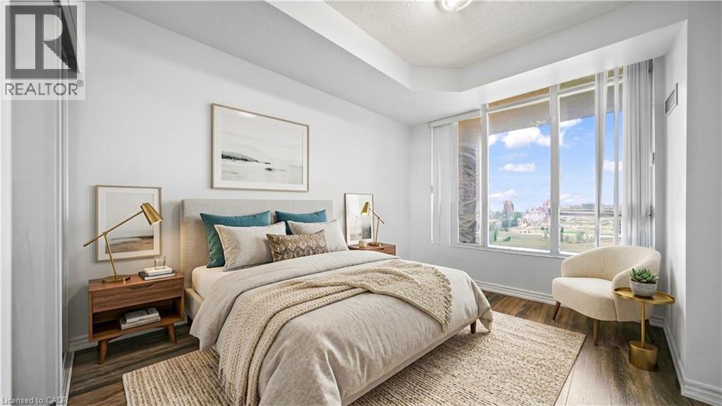 A bedroom with a large bed and a view of the outdoors through the window.