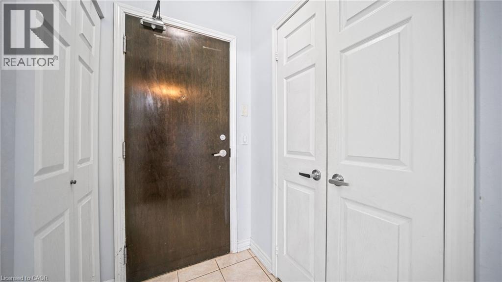 A white door is closed and a metal door is open.