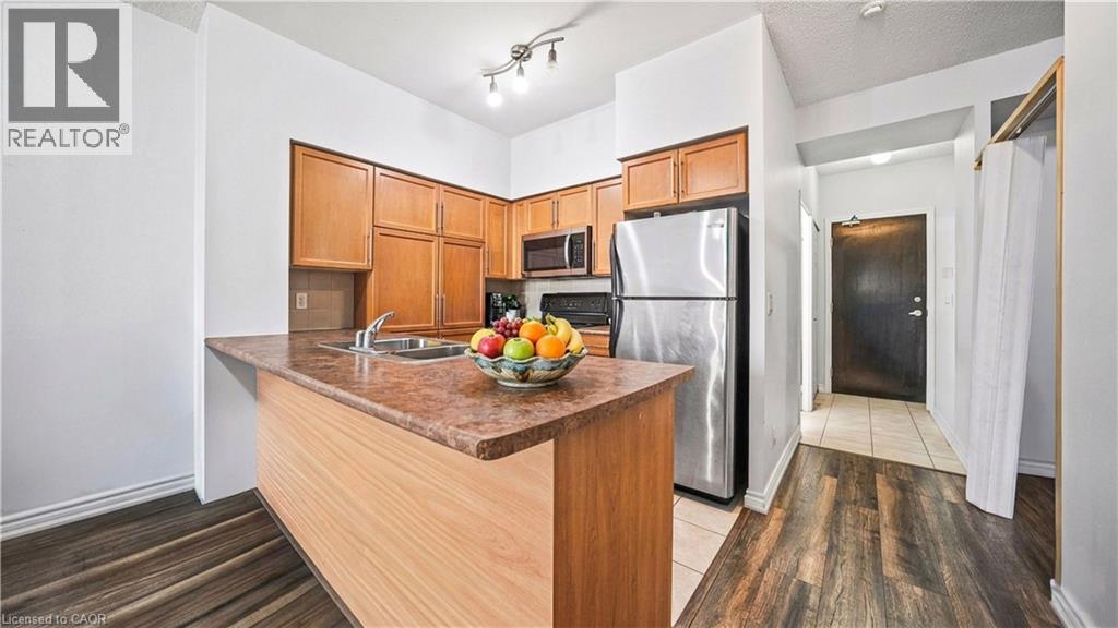 A kitchen with a wooden island and a refrigerator.
