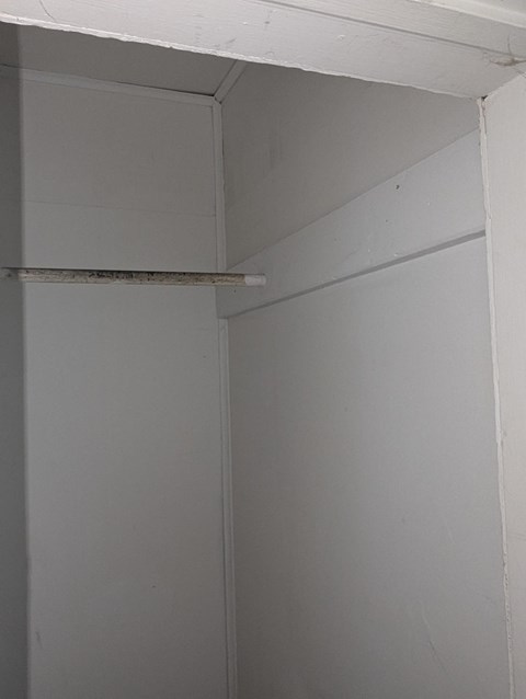 A white wall with a small gap in the corner.