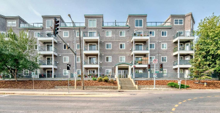 A large apartment building with a no parking sign in front.