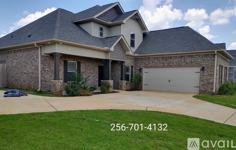 A house with a stone facade and a garage door.