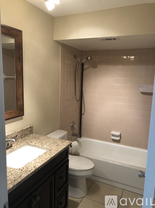 A bathroom with a toilet, sink, and bathtub.