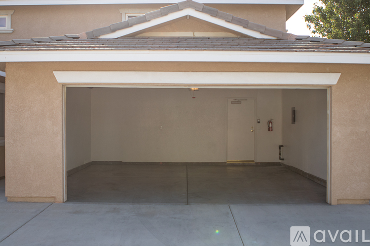 A garage with a beige wall and a white door.
