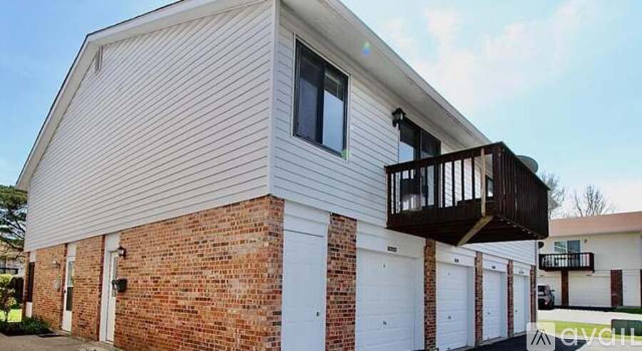 A house with a balcony and a garage.