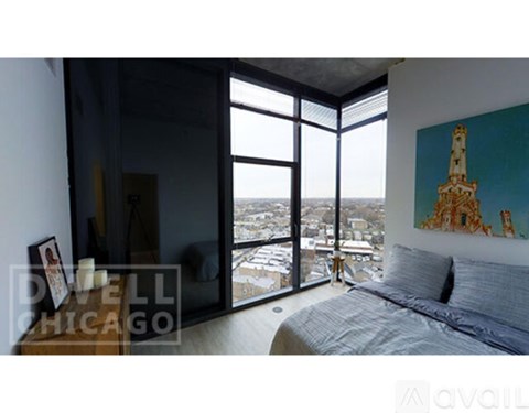 A bedroom with a large bed and a view of the city.
