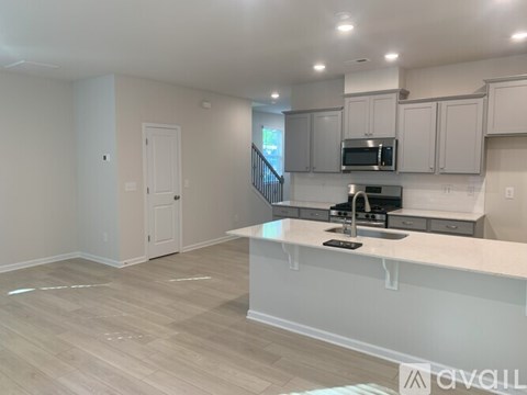 A kitchen with white cabinets and a countertop.
