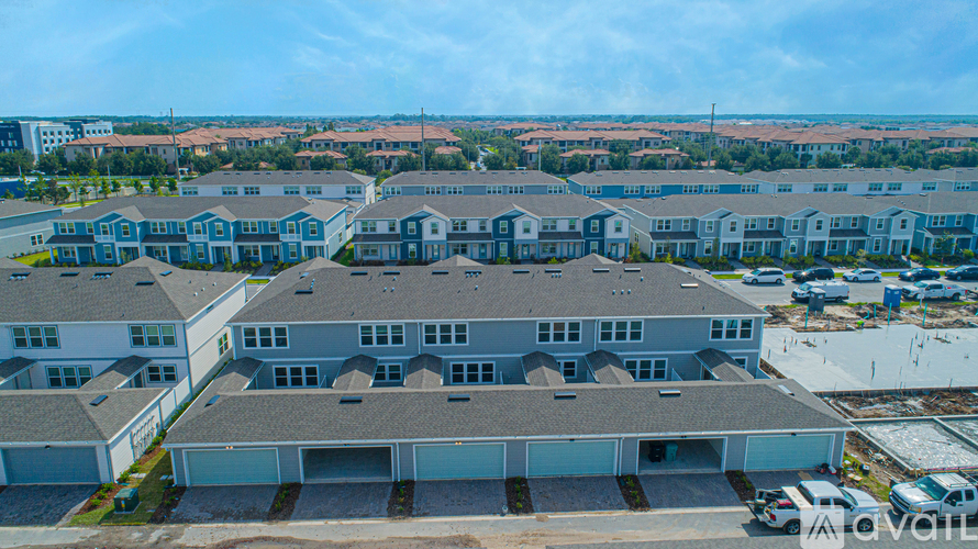 A large building complex with multiple garages and a clear sky above.