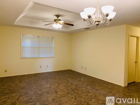 A room with a ceiling fan and a chandelier.