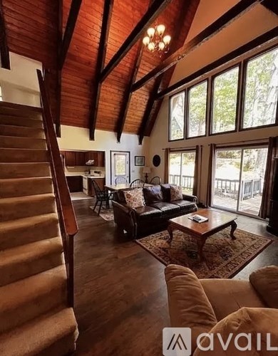 A living room with a staircase on the left side.