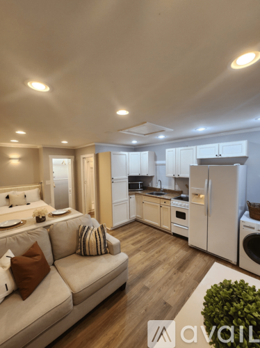 A modern kitchen with a washing machine and a refrigerator.