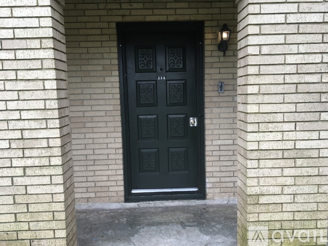 A black door with a mailbox on the right side.