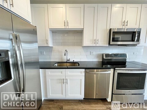 A kitchen with white cabinets and stainless steel appliances.