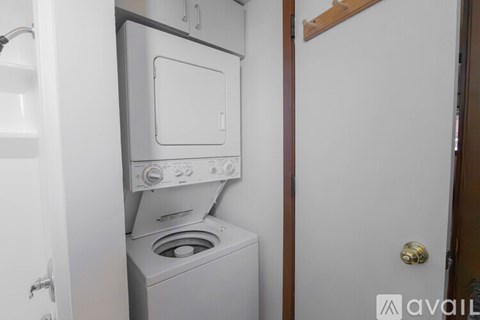 A white dishwasher is built into a kitchen cabinet.